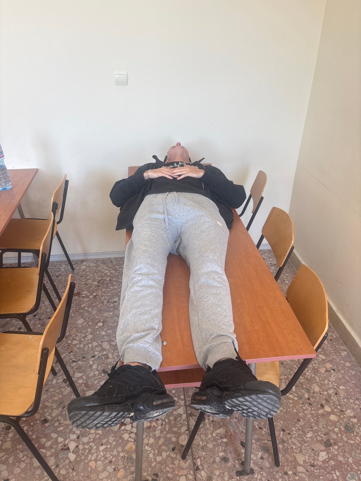 Student lies upside down on classroom desk in Plovdiv