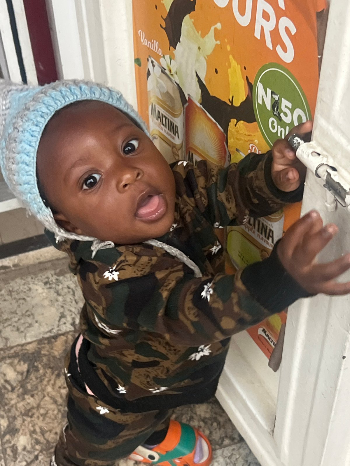 Toddler's playful moments captured indoors in Gura Top, Nigeria