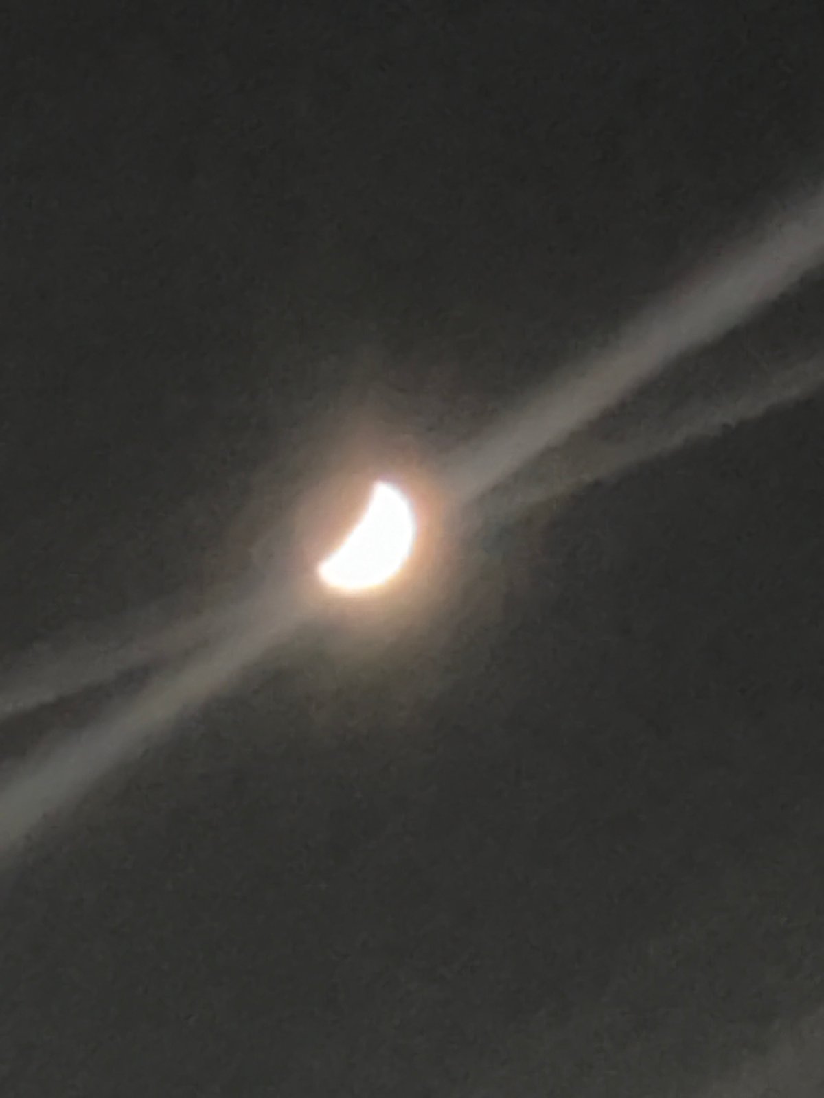 Crescent celestial object observed during apparent partial eclipse event