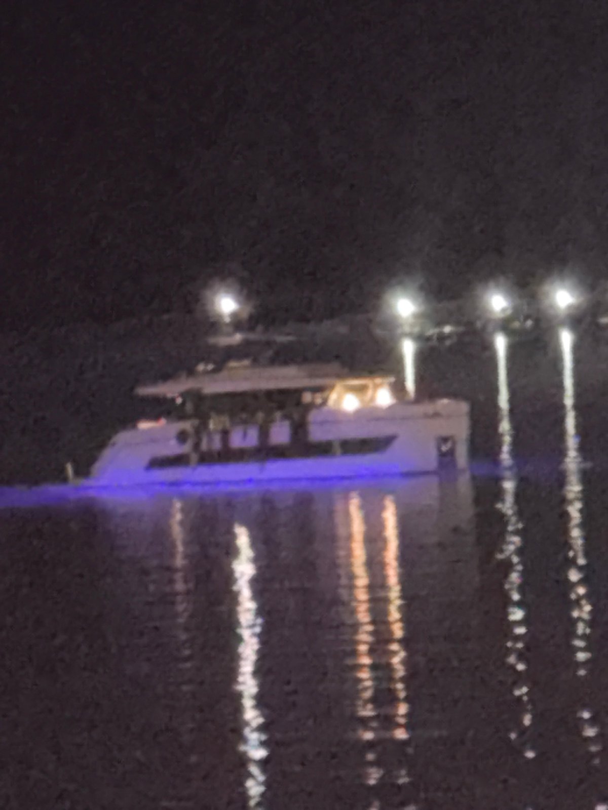 Budva waterfront at night — yachts, coastline, and resort life