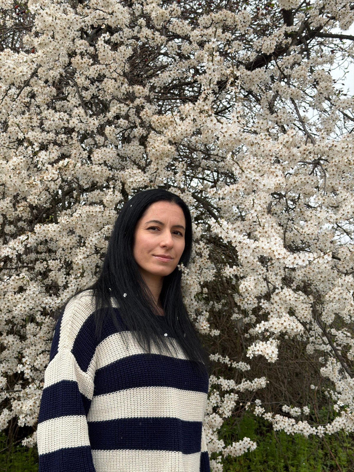 Woman rests among flowering trees in Pleven park