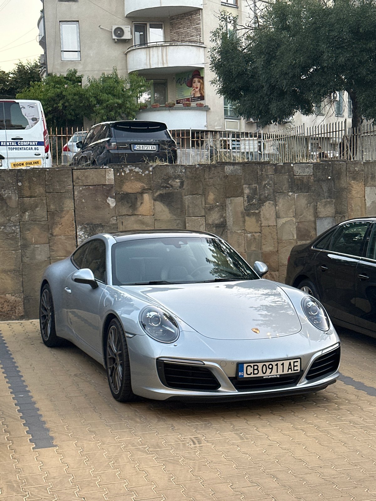 Exotic cars parked in Veliko Tarnovo on a grey afternoon