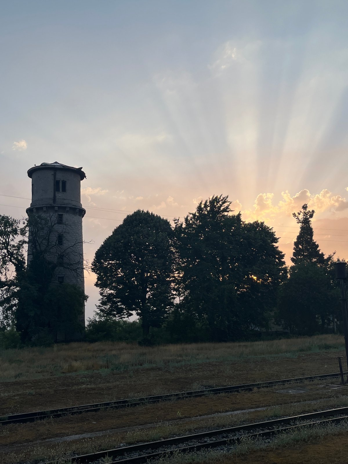 Bansko at sunset: stone water tower and mountain-backed streets