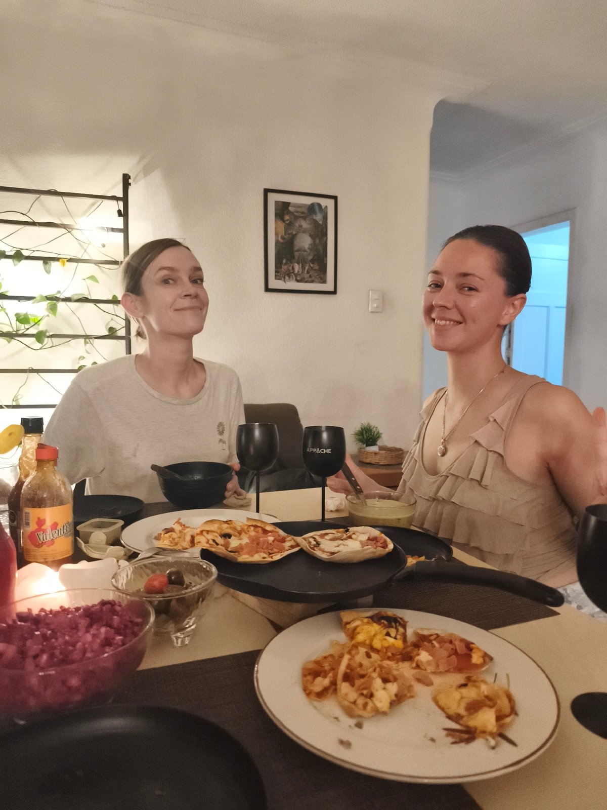 Women share late-night pizza dinner at Mexico City home