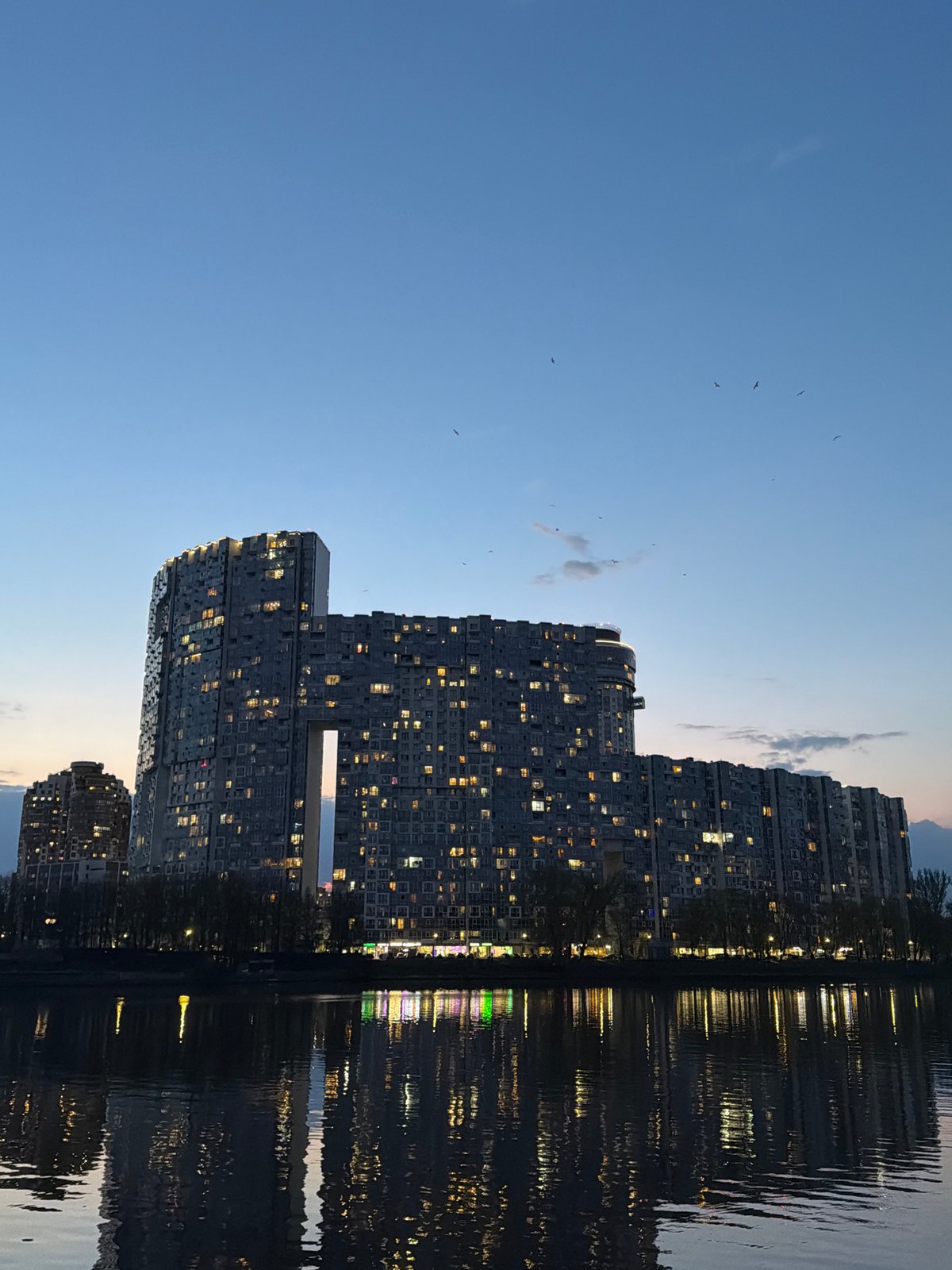High-rise apartments reflected in water observed in Khimki