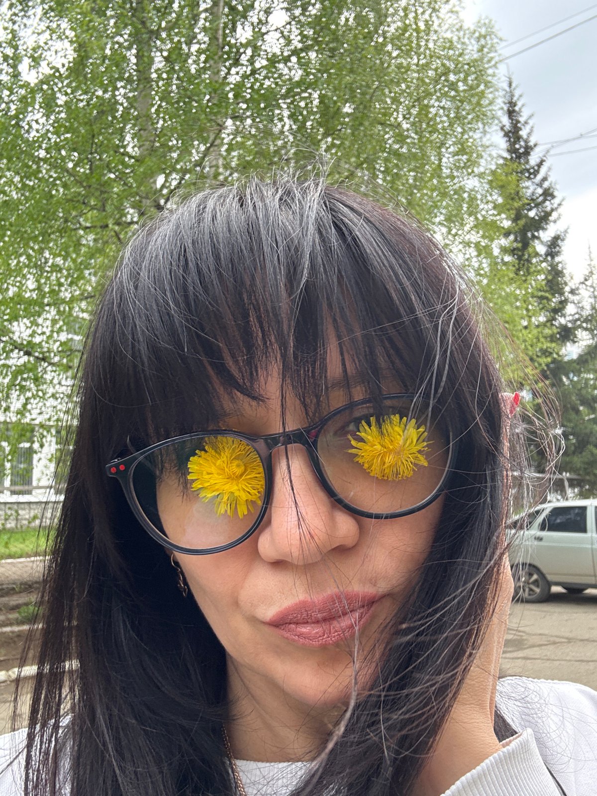 Woman poses with dandelions during Chaikovsky, Russia visit