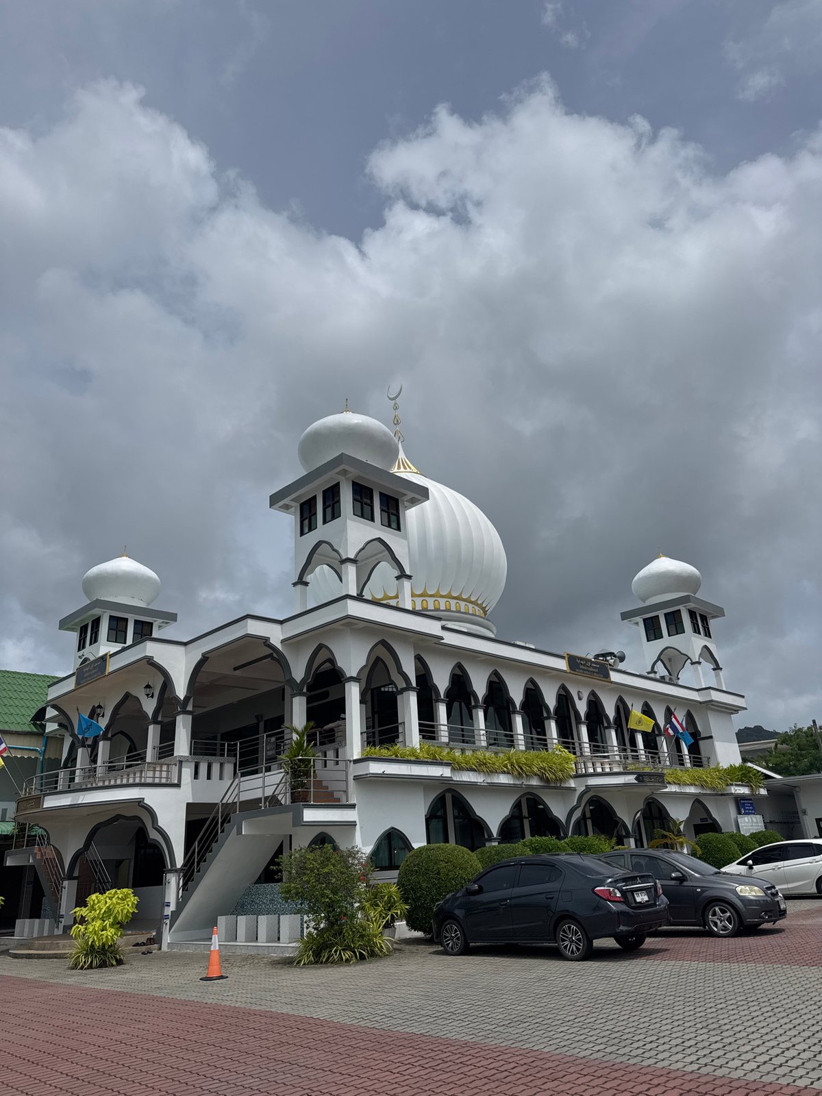 Rawai seafront on a cloudy morning — boats, mosque, coastline