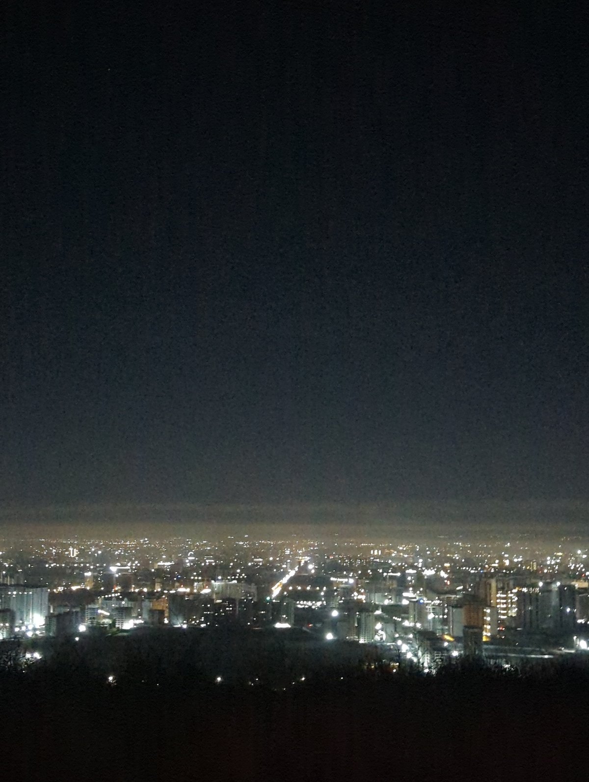 Nighttime aerial views of illuminated Bishkek cityscape captured