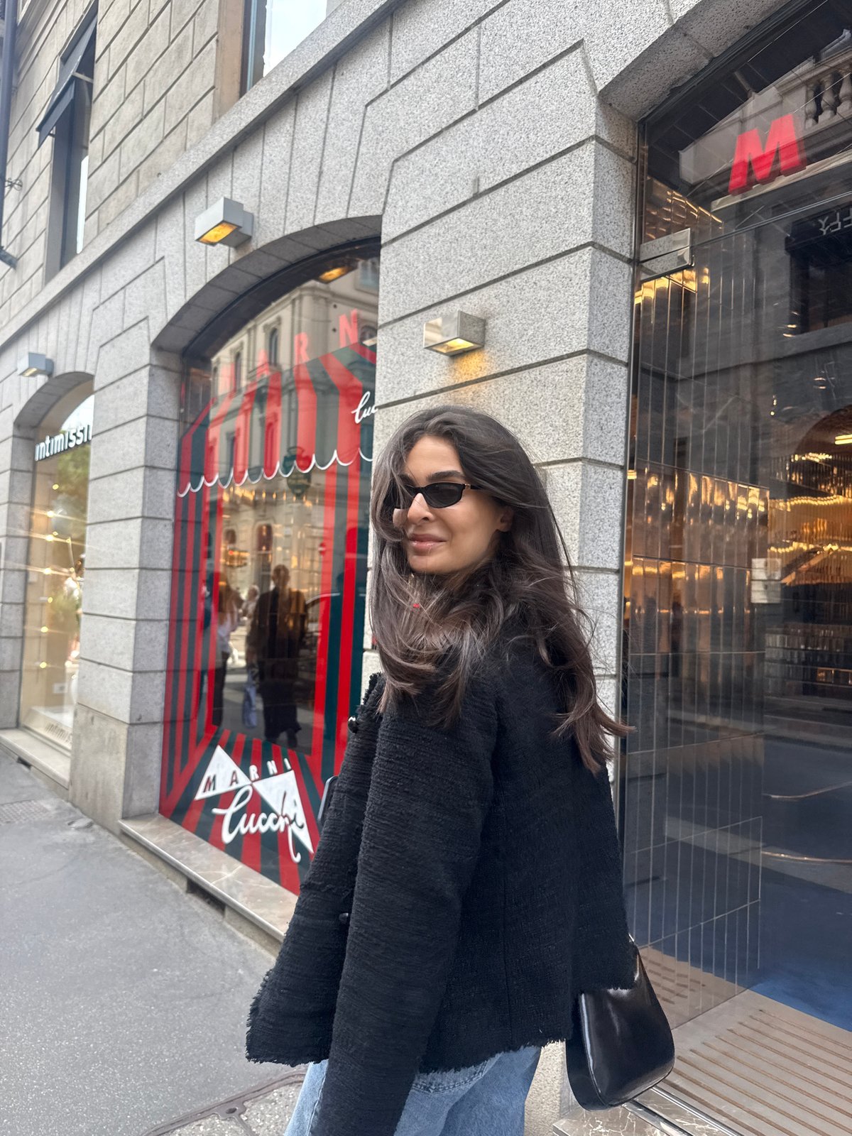 Woman stands outside Marni Lucci store in Milan