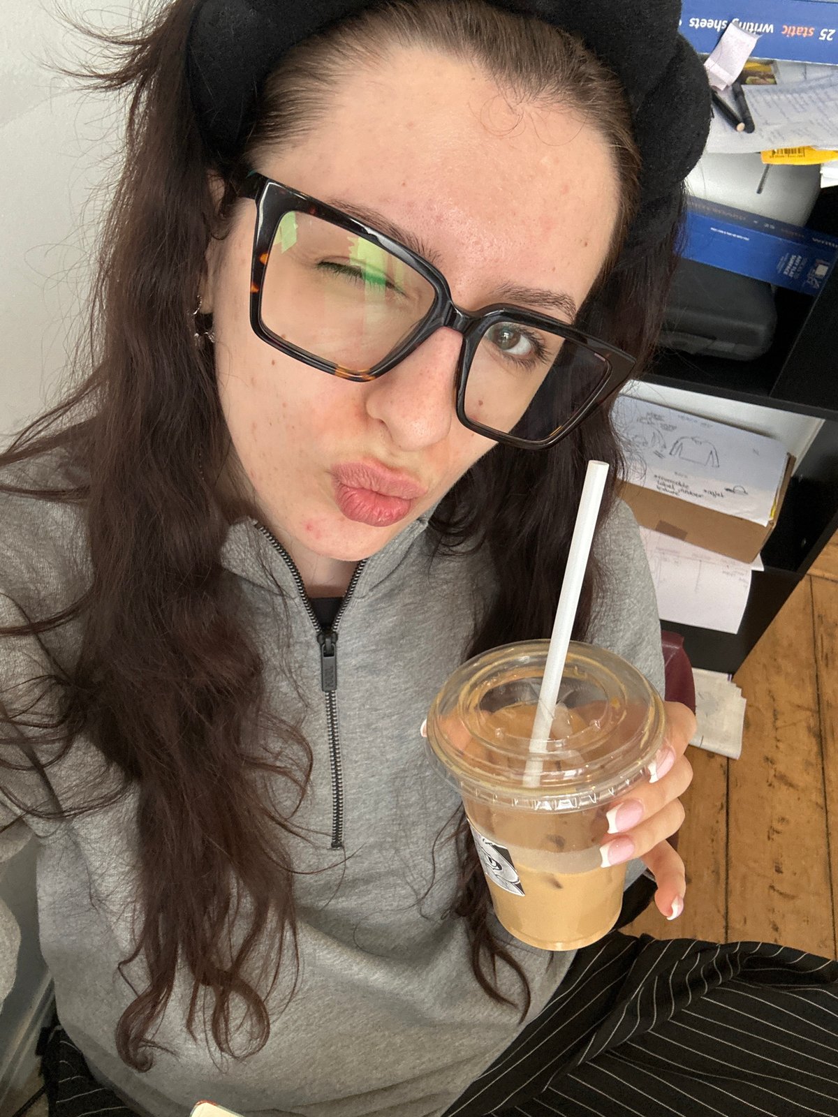 Woman documents coffee break workspace in Antwerp cafe
