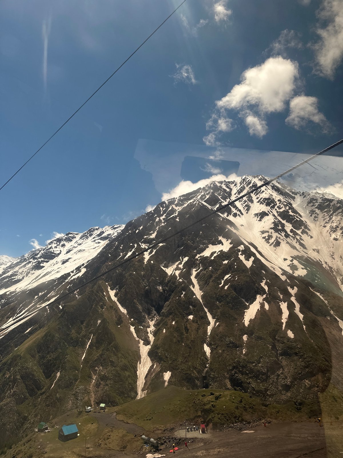 Cable car ascent through Terskol mountains with valley views