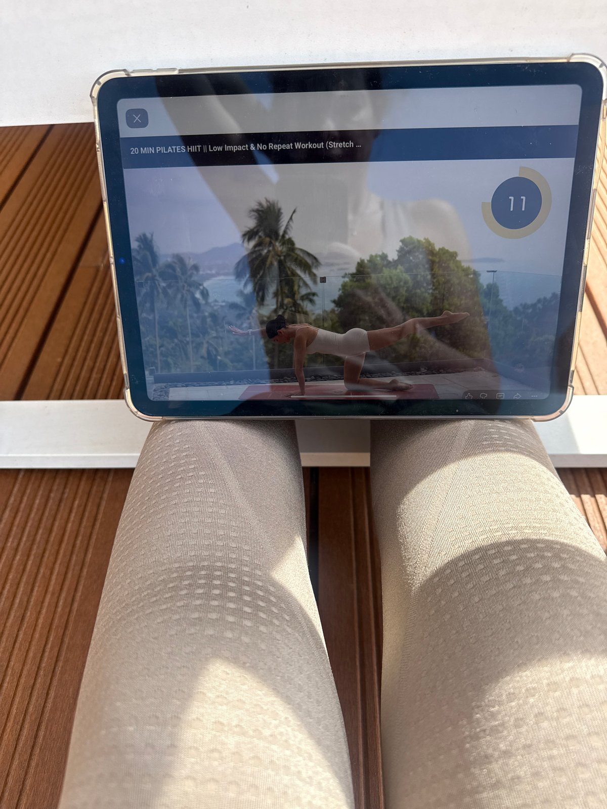 Person uses iPad on wooden deck in Vila Nova de Gaia