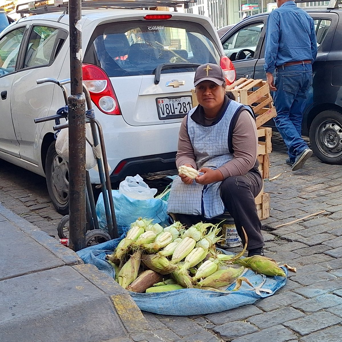 Street vendors sell fresh produce on cobblestone streets