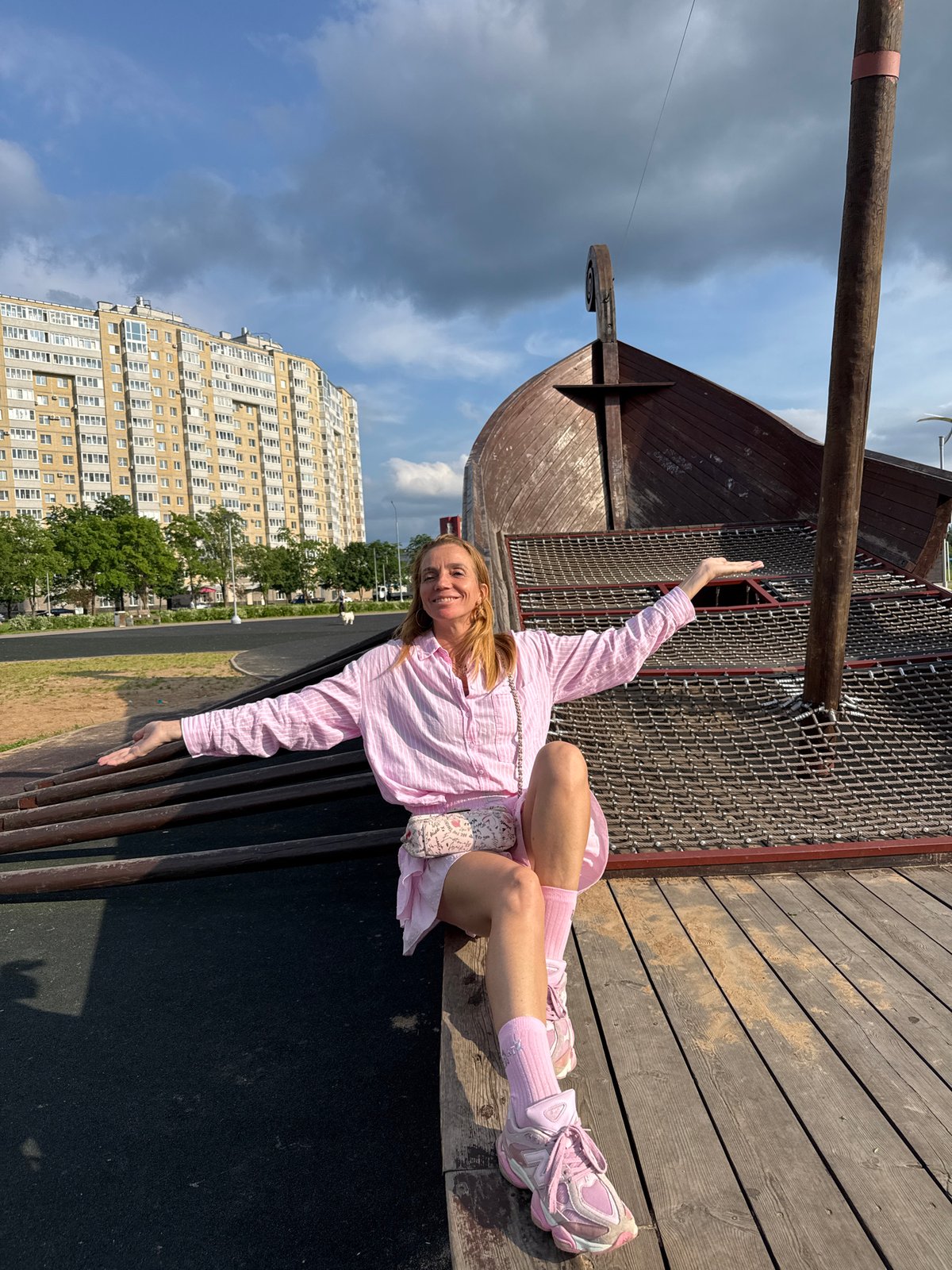 Tourist in pink explores Kirishi landmarks and waterfront