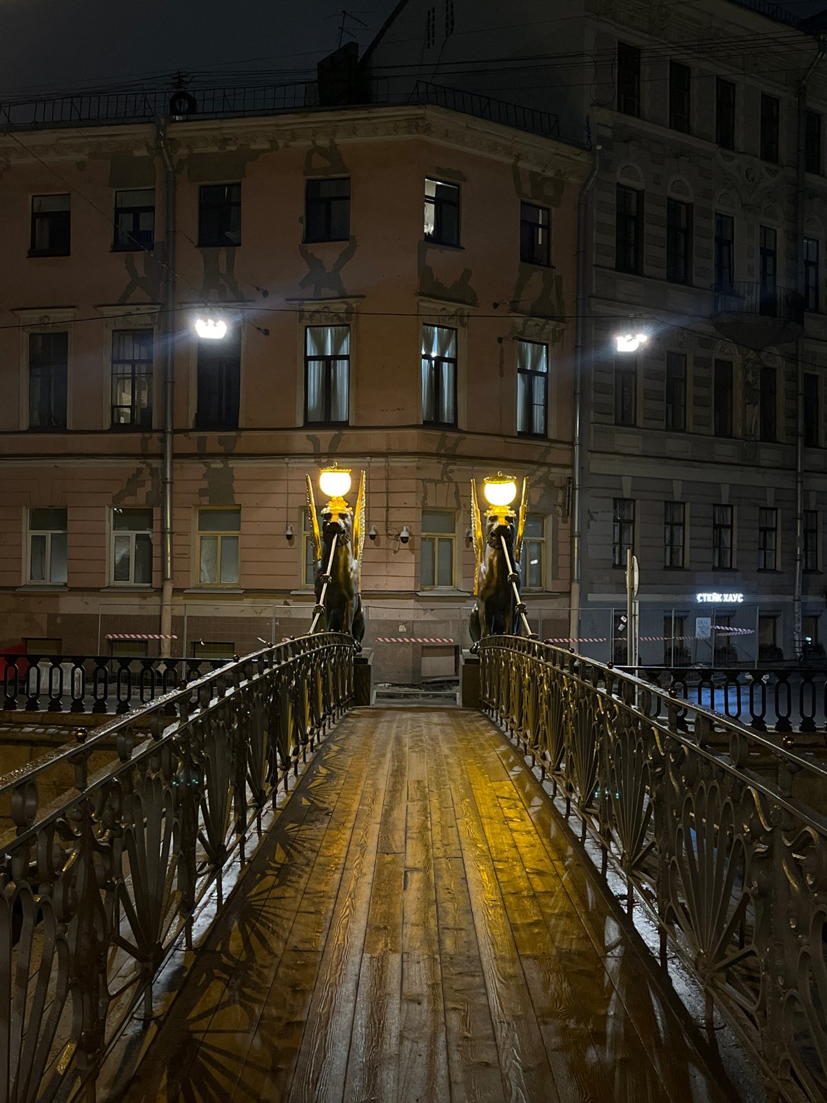 Evening documentation of ornate bridge features in Saint Petersburg