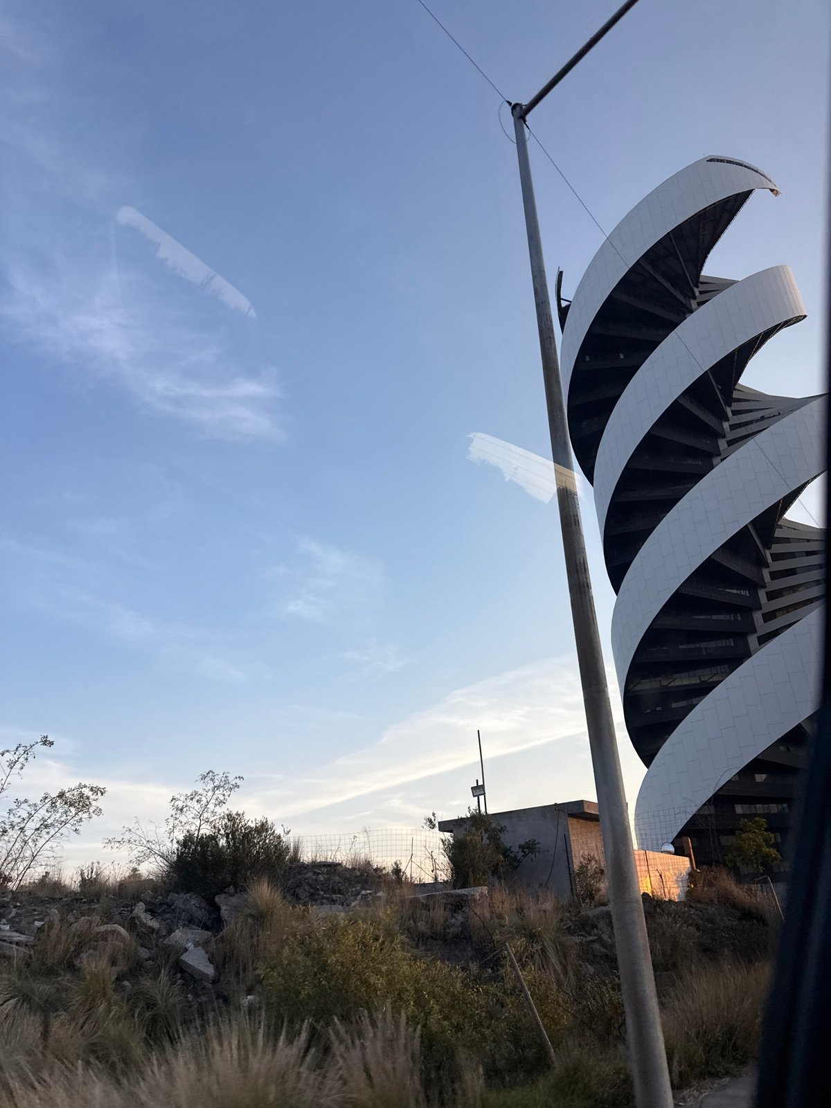 White curved architecture photographed in Mexican hillside community