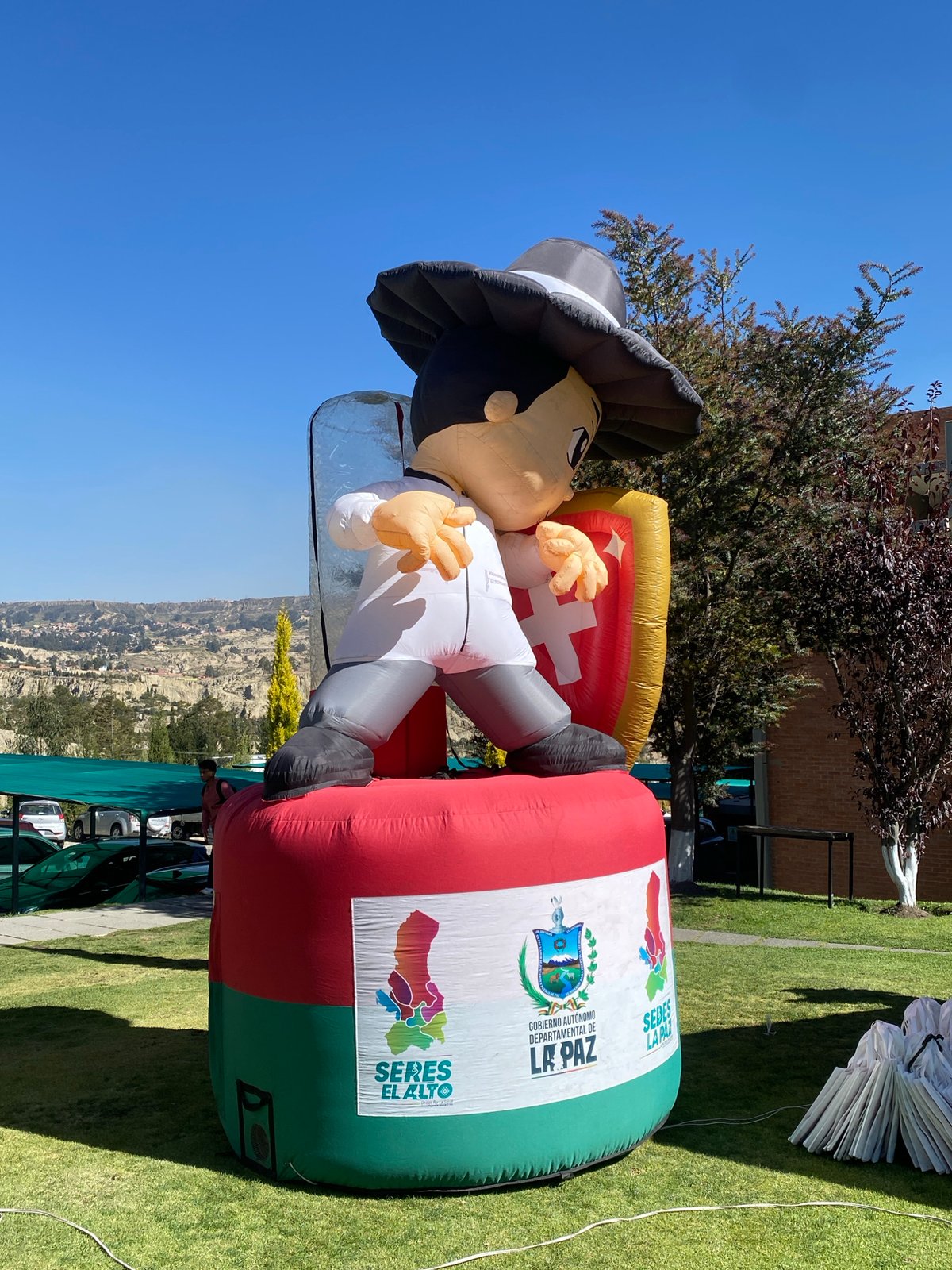 College students gather around inflatable mascot in Achocalla