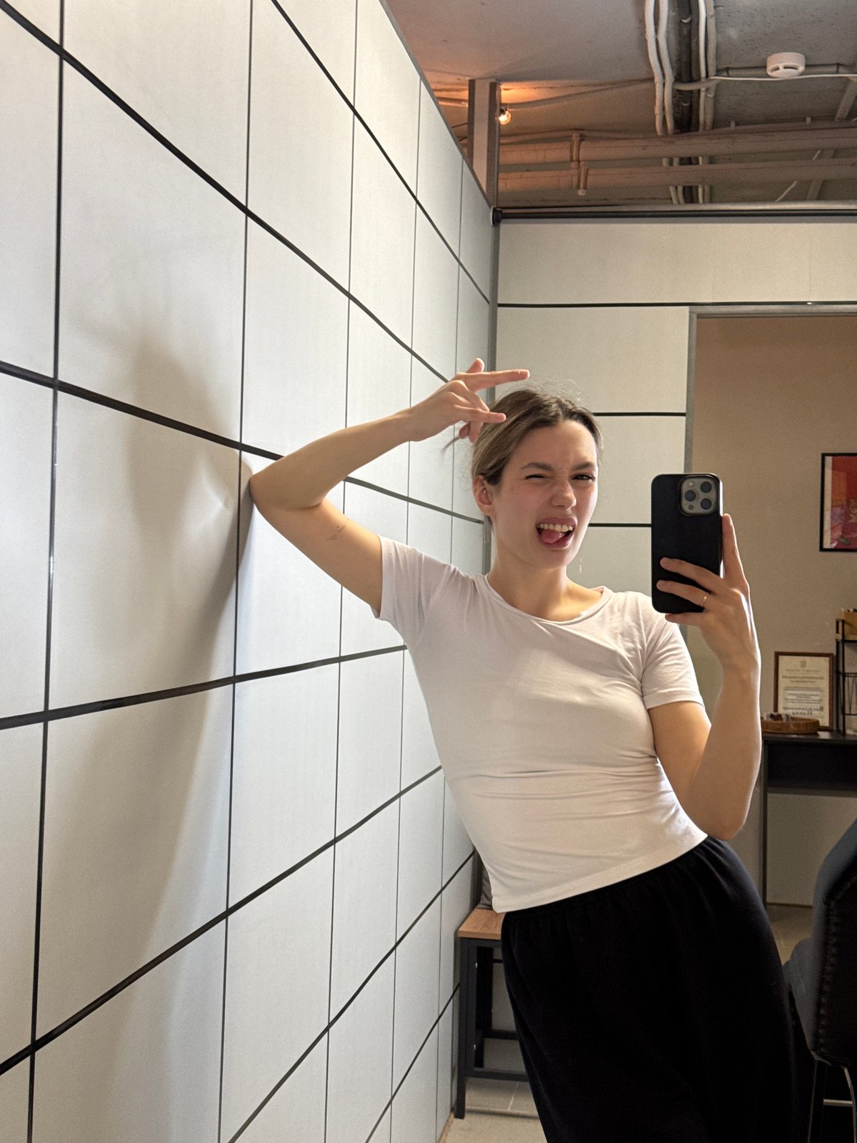 Young Woman Documents Selfie Session in Tattoo Studio Setting