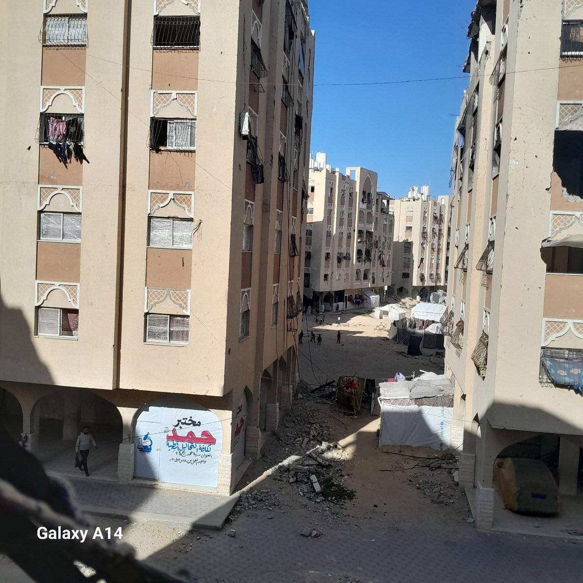 Damaged urban infrastructure observed through broken barrier