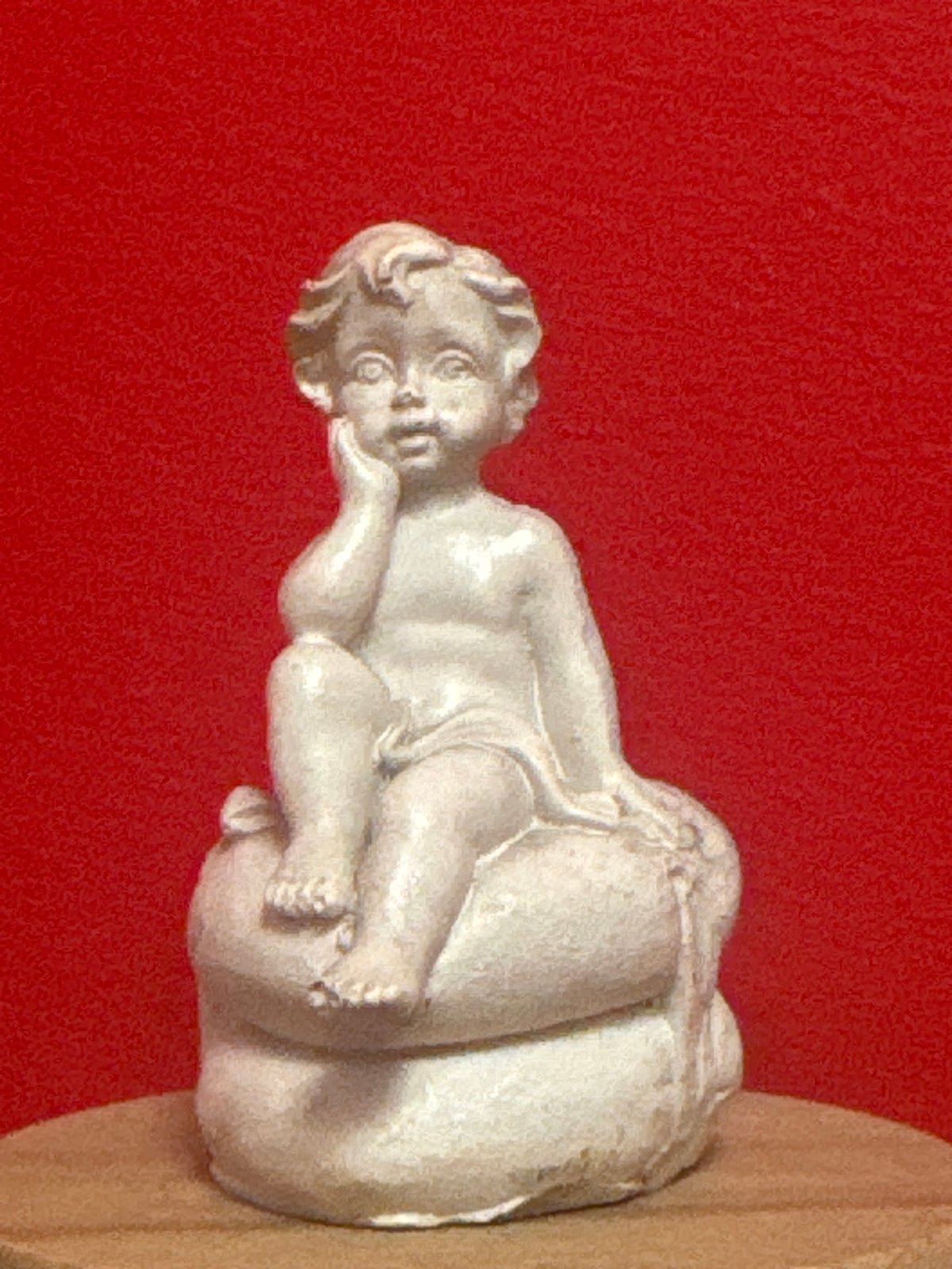 Decorative figurines and colorful puzzles displayed against red in Almaty