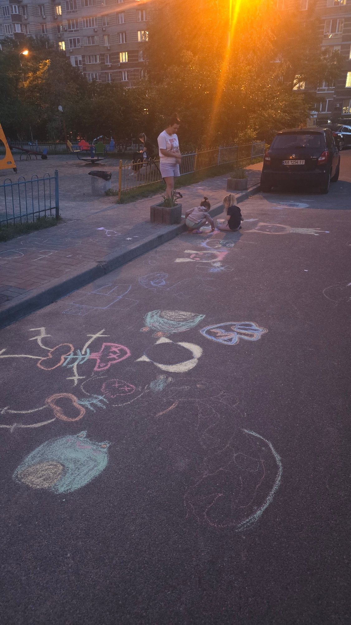 Evening chalk art session in Kyiv residential courtyard