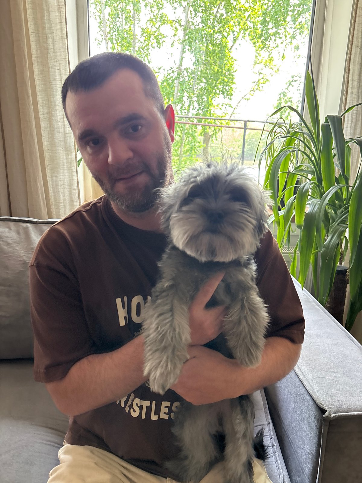 Couple photographs grey dog in playful indoor session