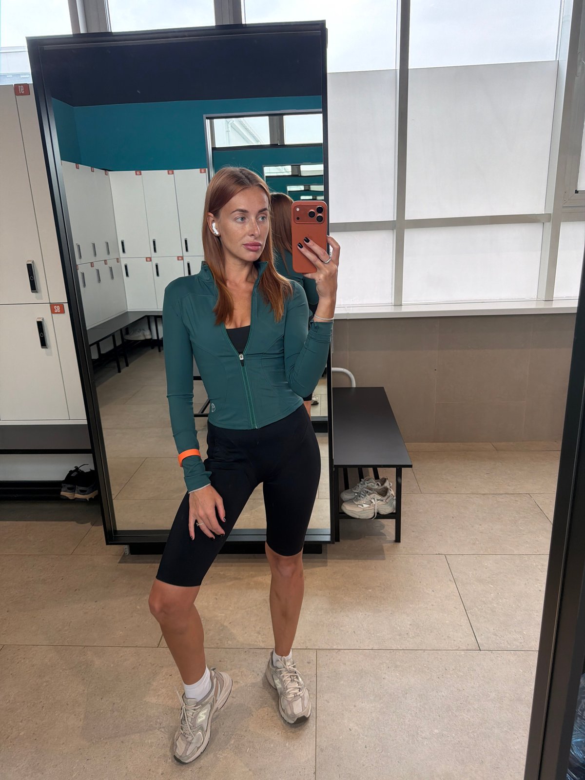Woman documents workout session with locker room selfies