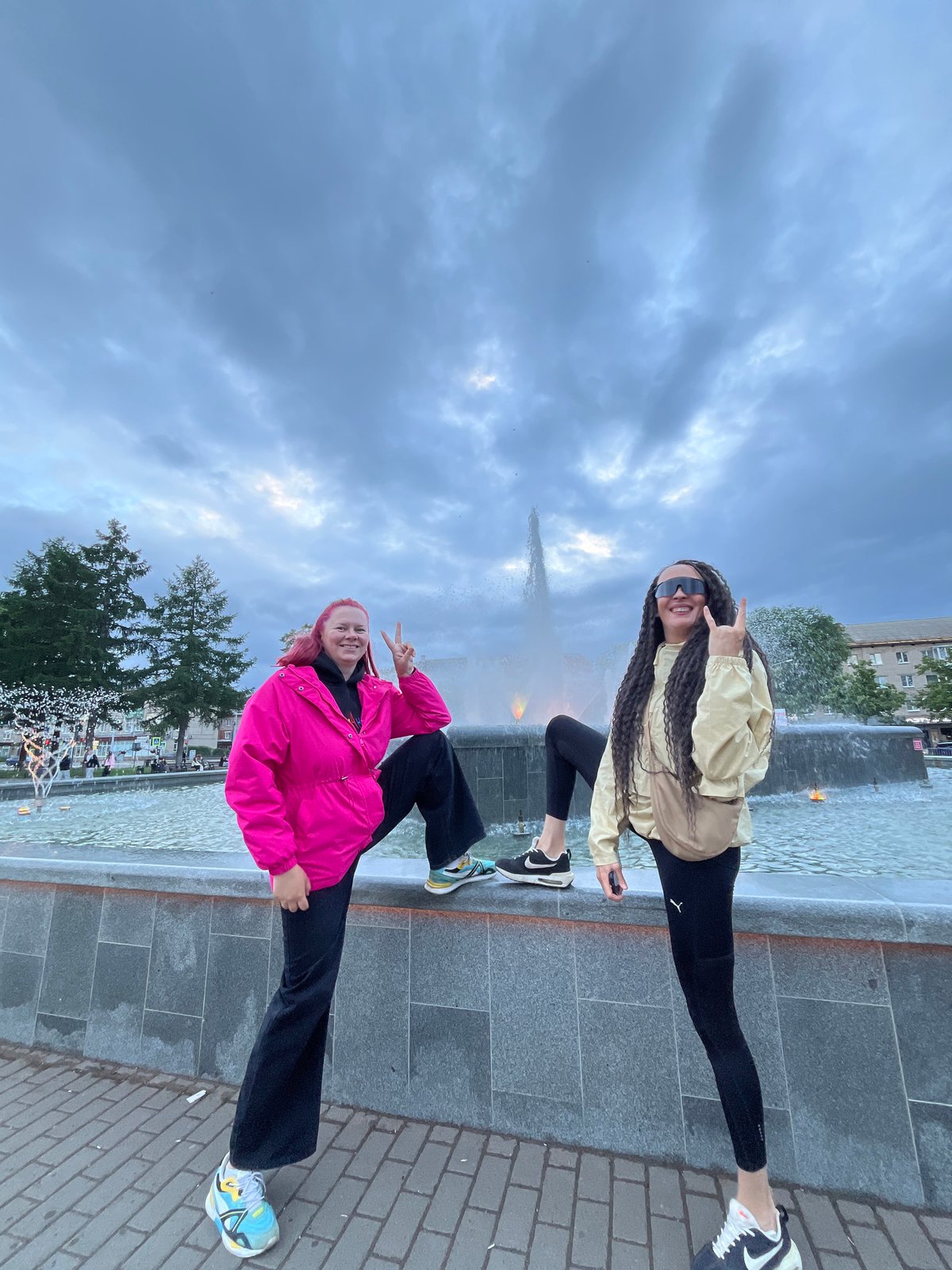 Families and visitors gather at Chaikovsky fountain during overcast afternoon