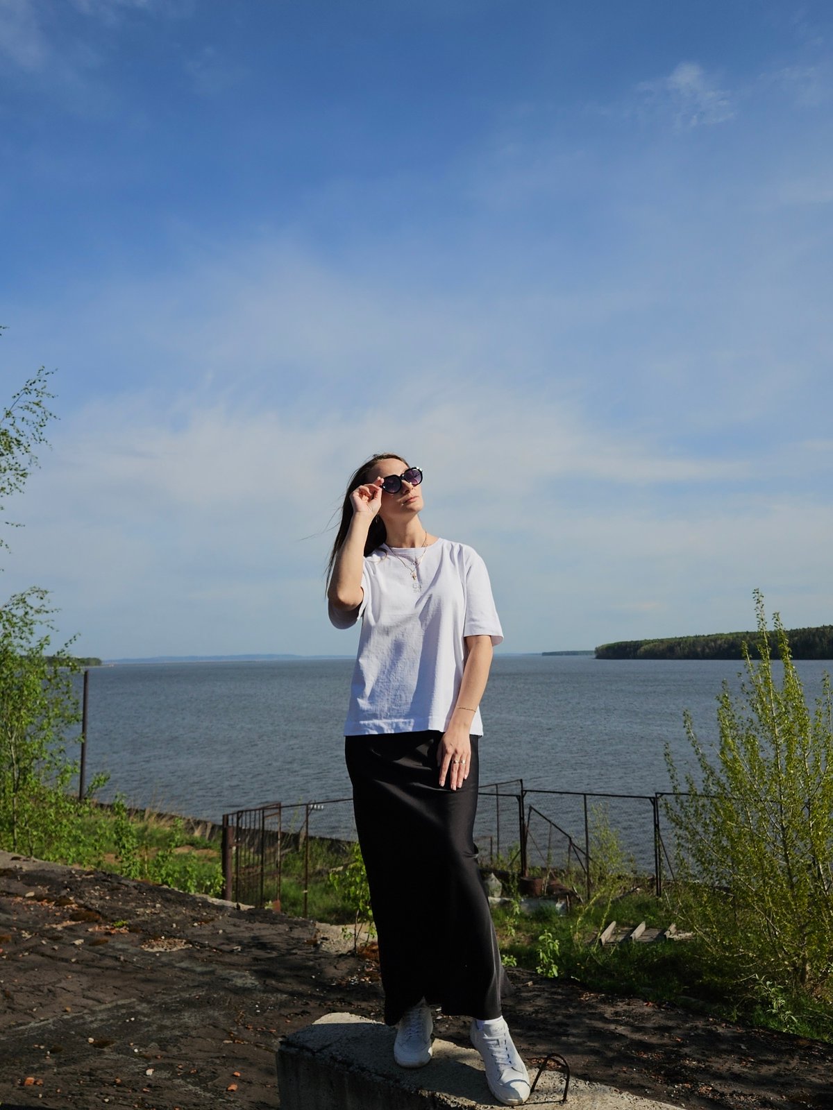 Woman poses for photos near water in Chaikovsky, Russia