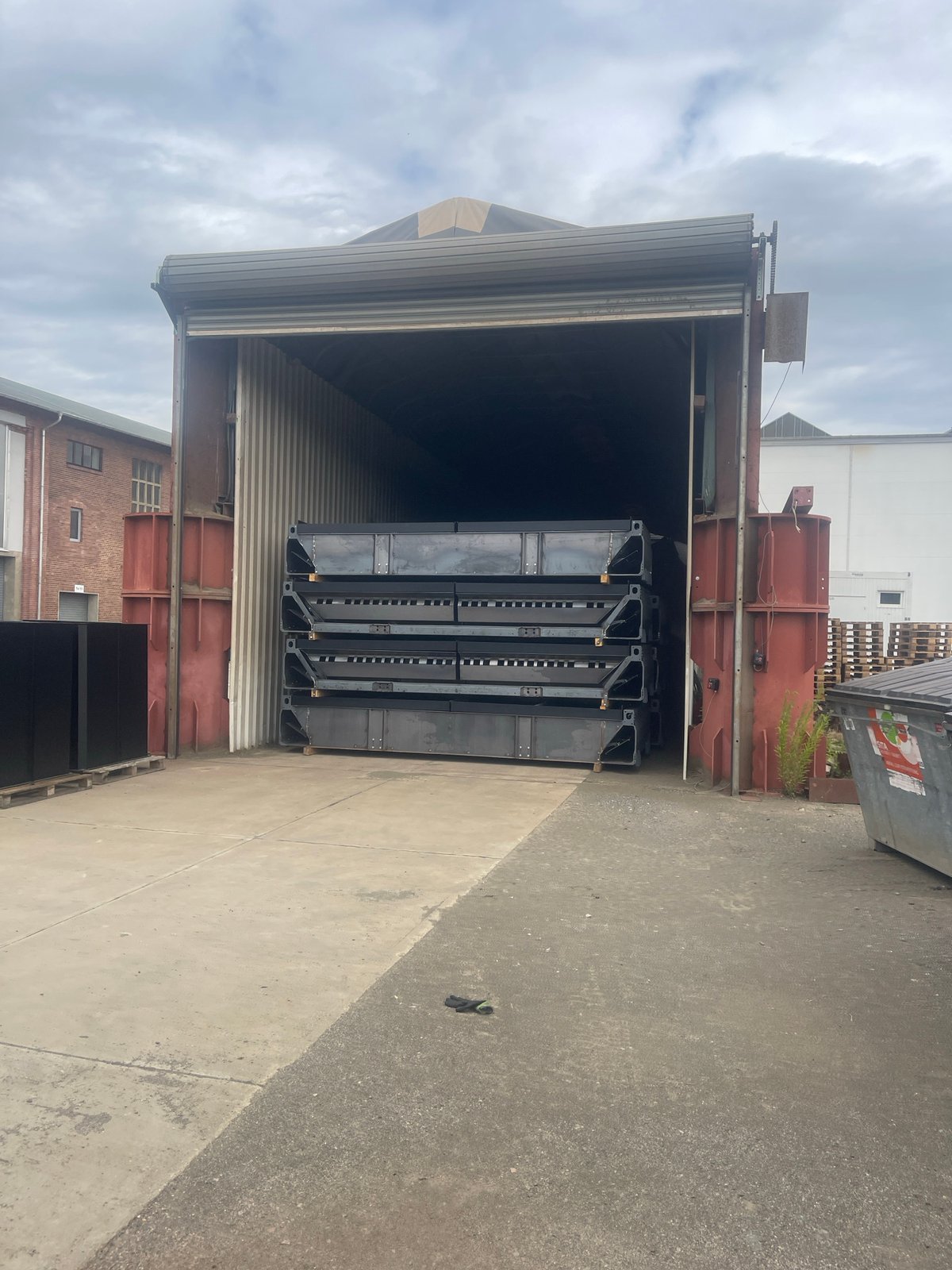 Inside a heavy industrial yard: forklifts, SPMTs, and large equipment