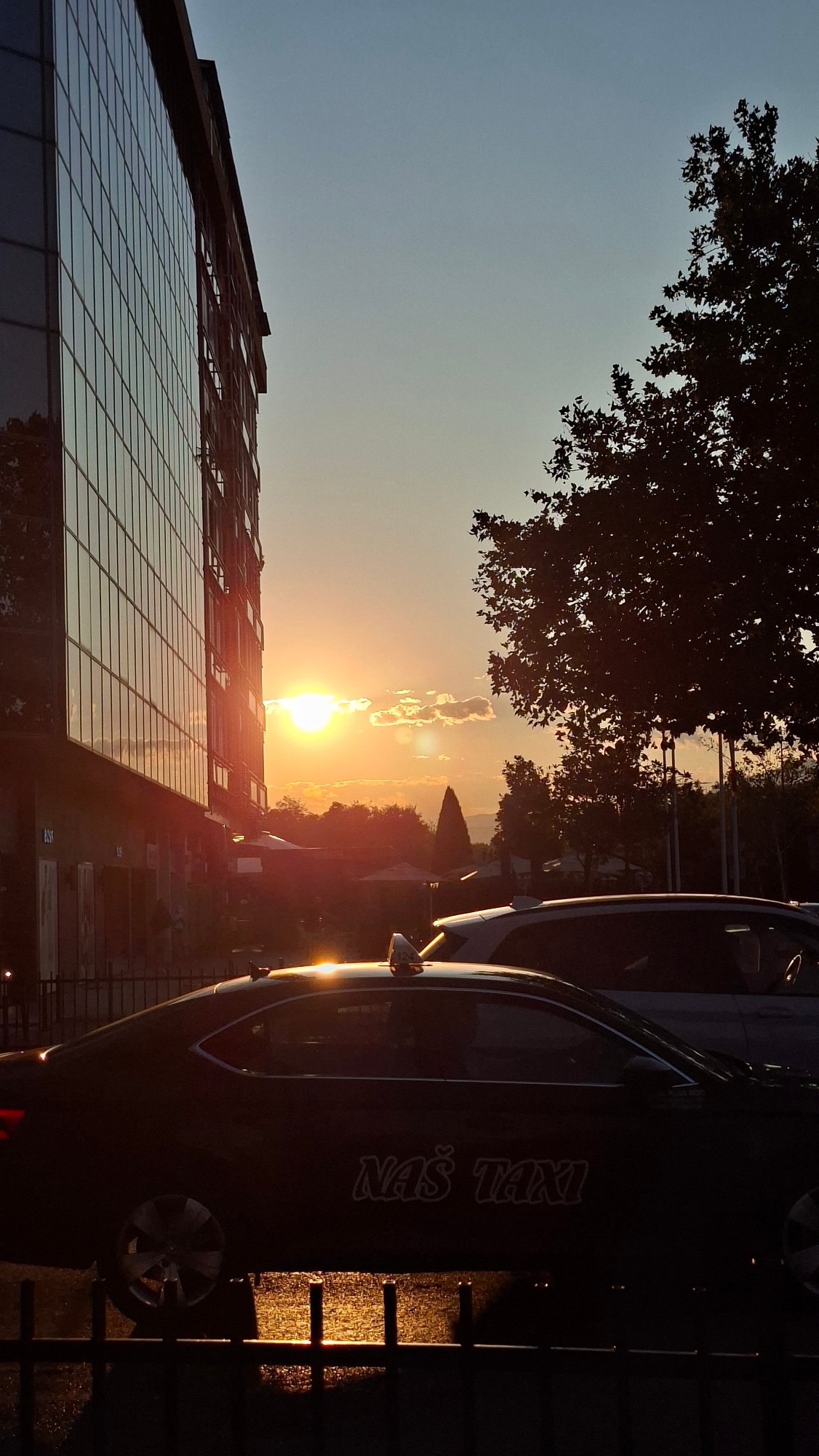 Golden-hour streets in Podgorica, with a Teatro Budva poster nearby