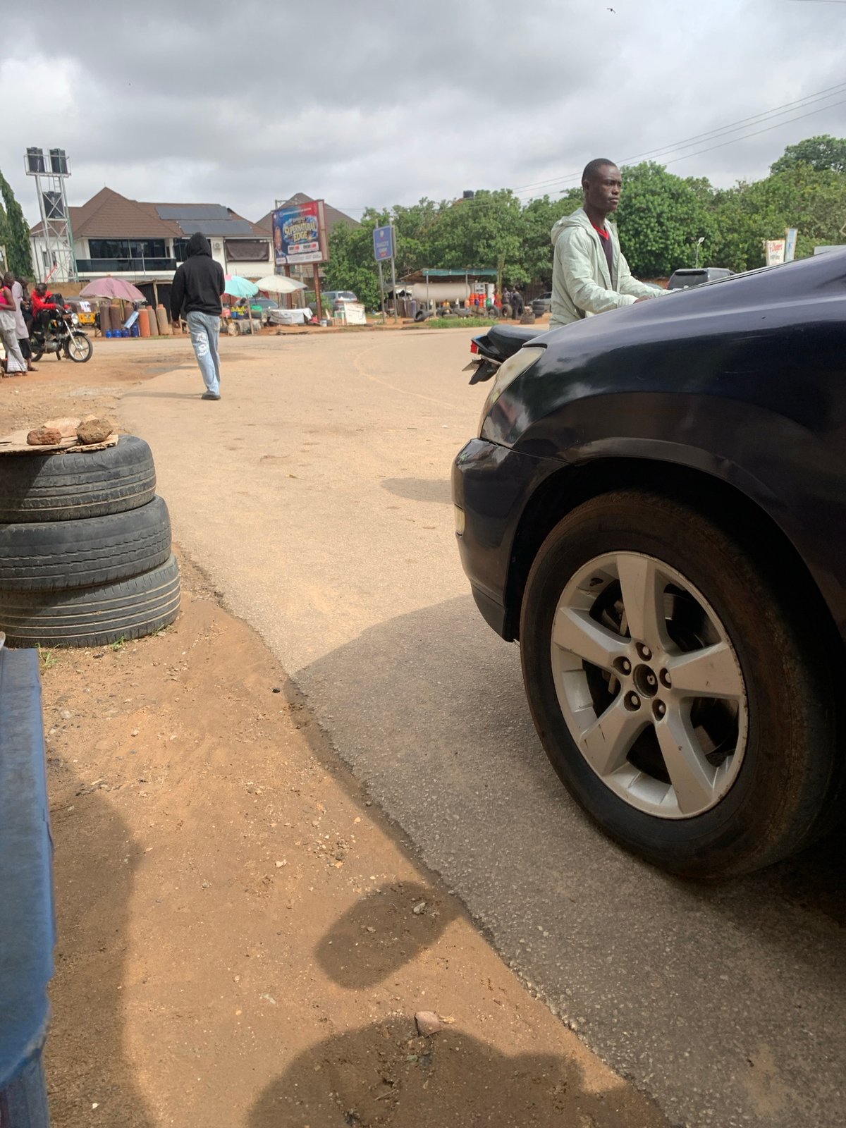 Morning street life unfolds across Abuja on overcast Saturday