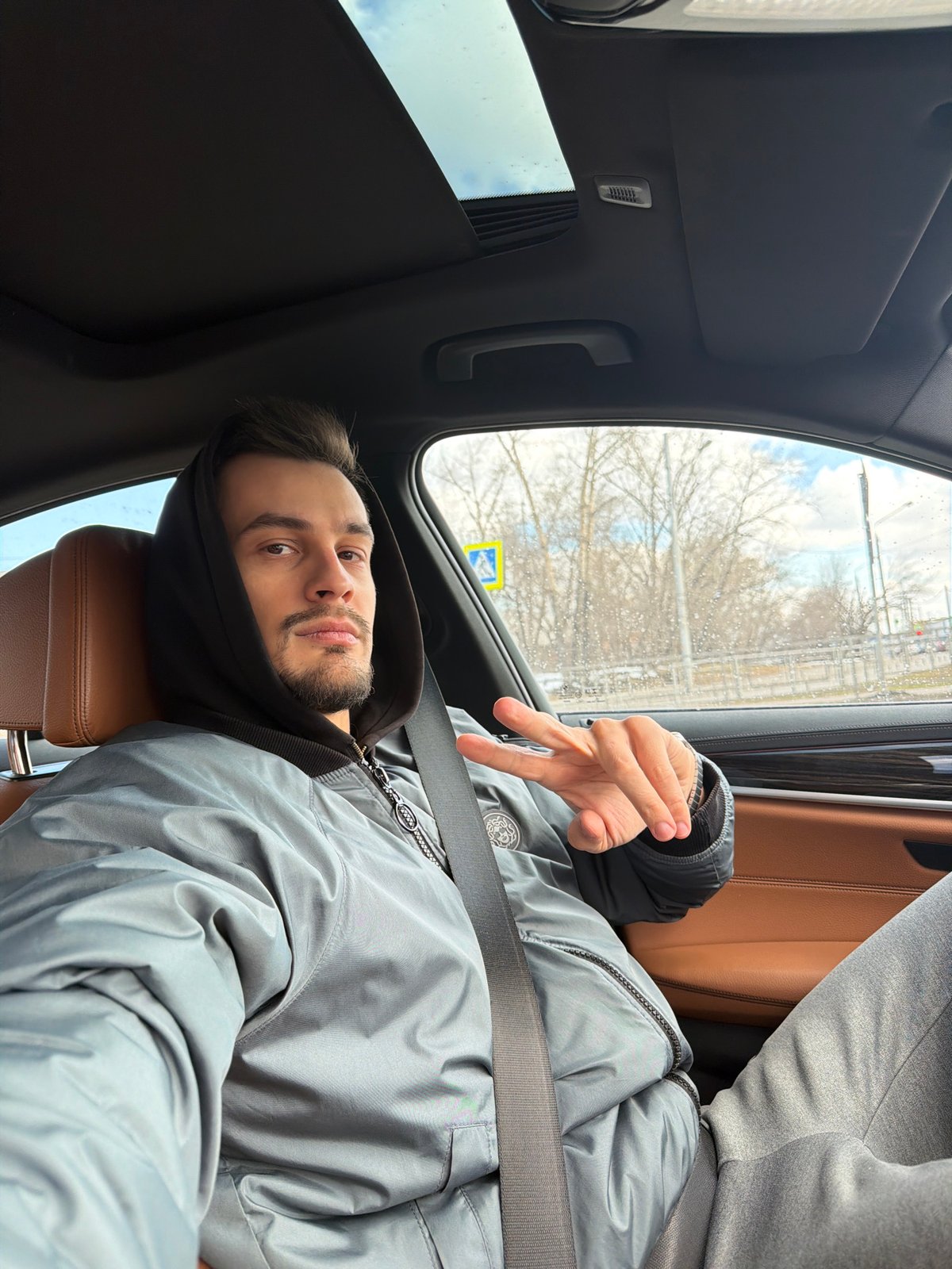 Man poses in BMW with peace sign in Krasnoyarsk