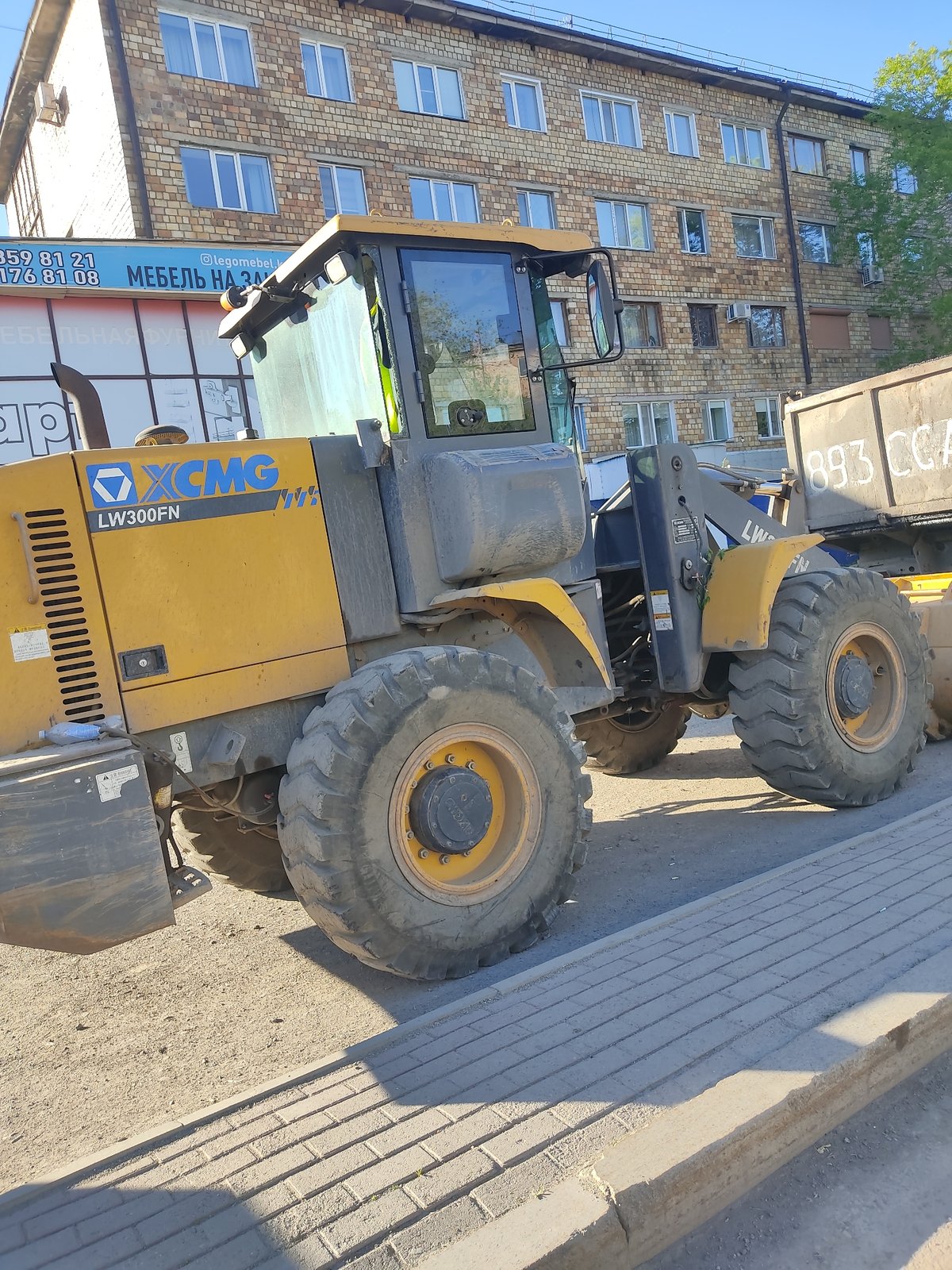 Construction Equipment Parked on Street Near Building