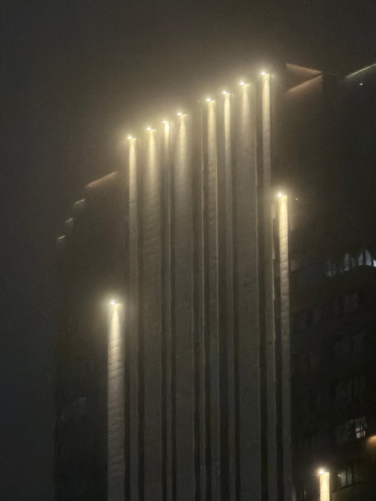 Fog and artificial light across Yekaterinburg after dark