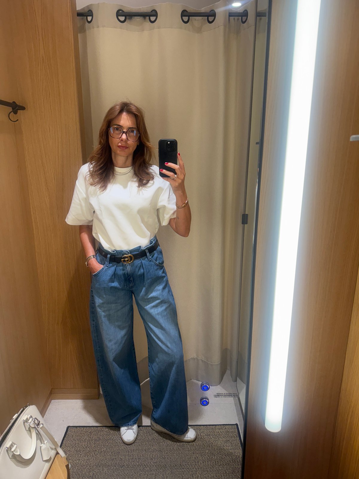 Woman takes mirror selfie in Loures store changing room