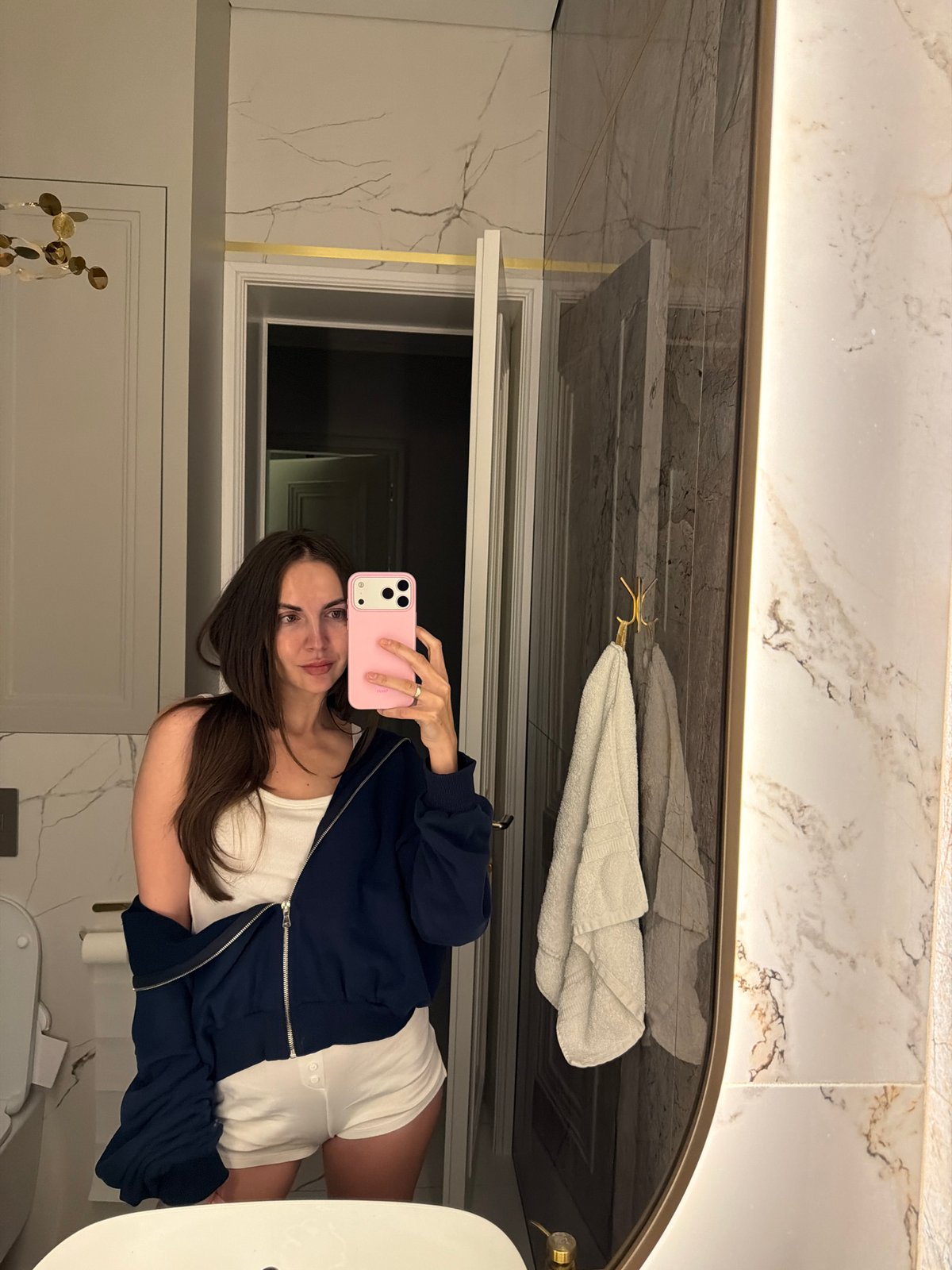 Woman takes bathroom mirror selfie in Krasnoyarsk
