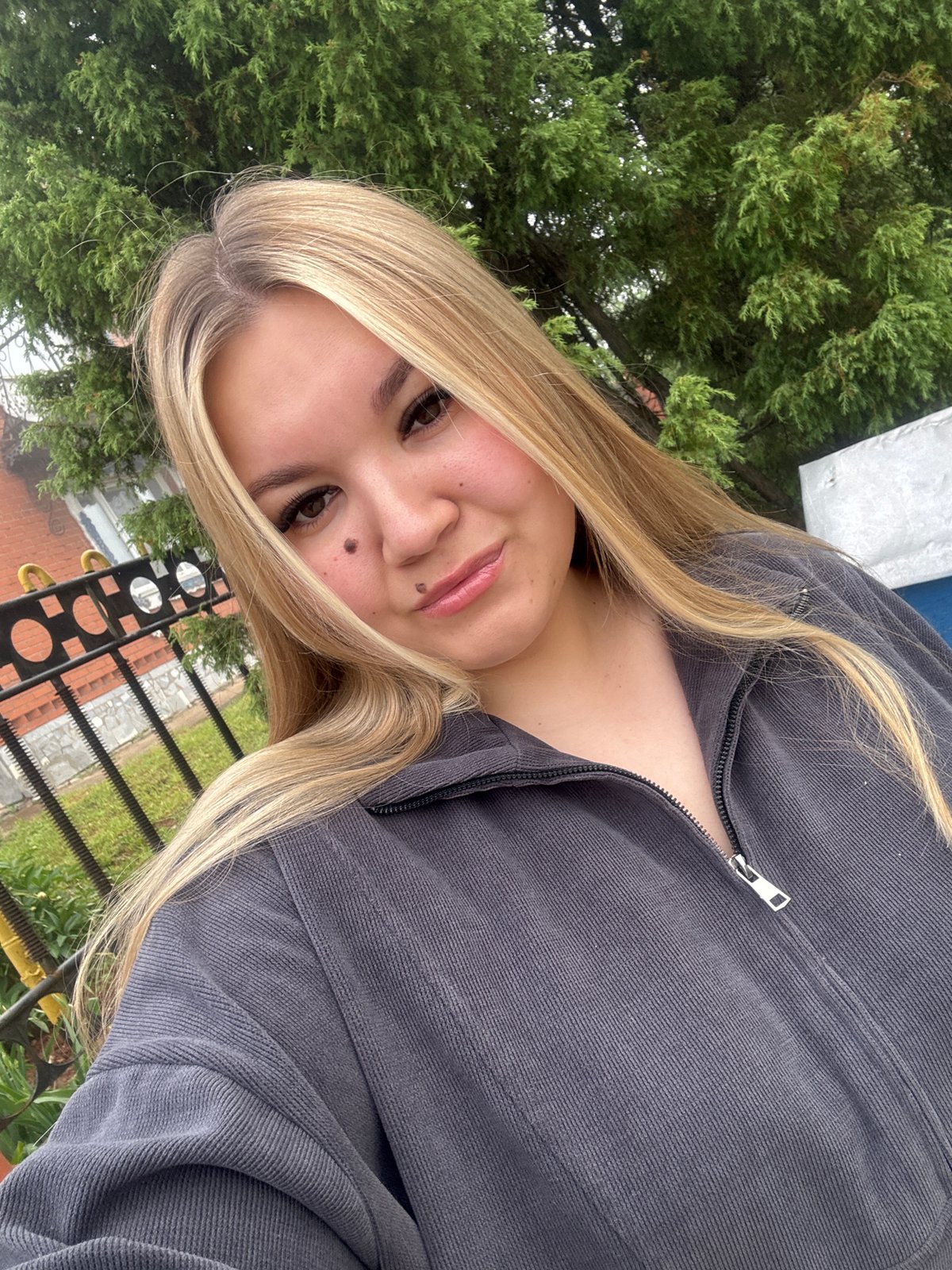 Young woman documents foggy morning walk in Russian village