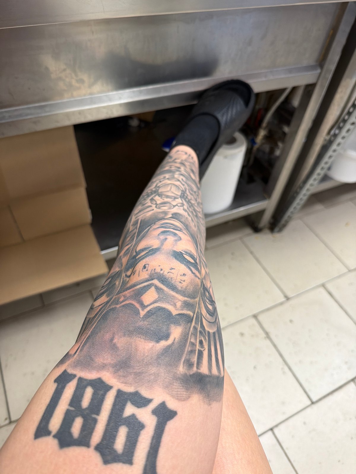 Person with tattooed leg photographed in Plovdiv commercial kitchen