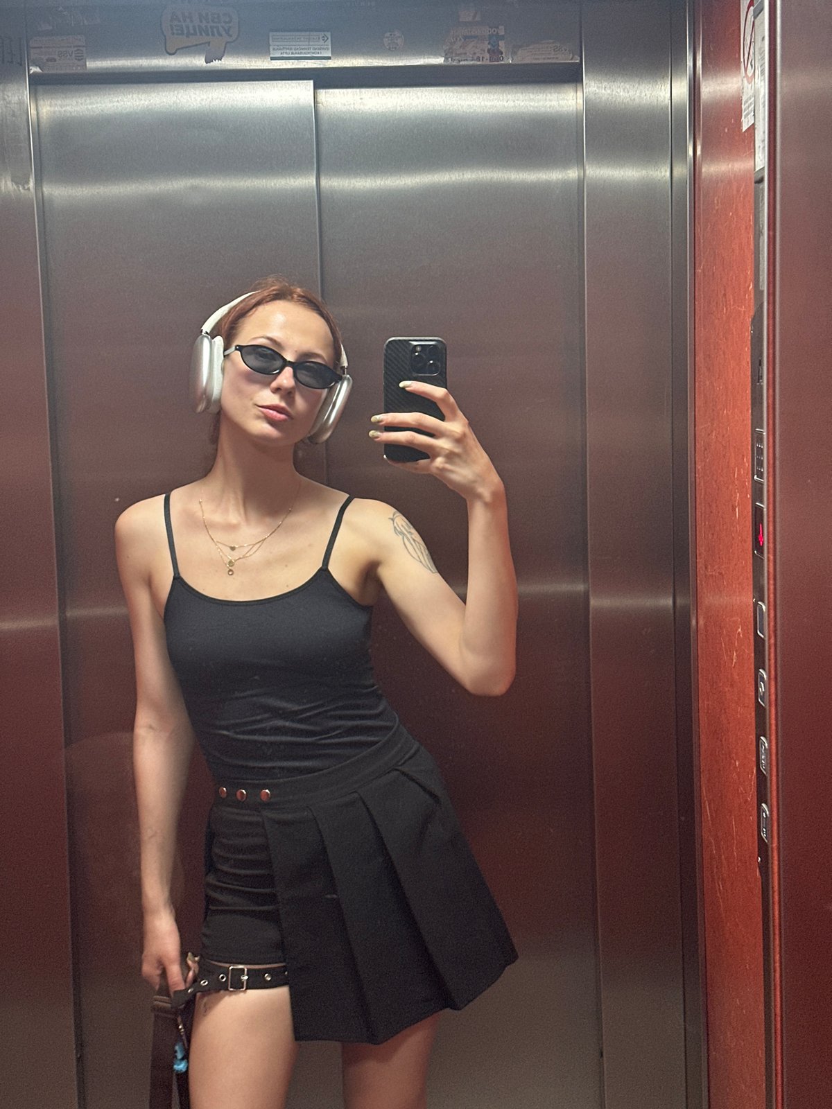 Woman Takes Multiple Elevator Selfies With Plant in Novi Sad
