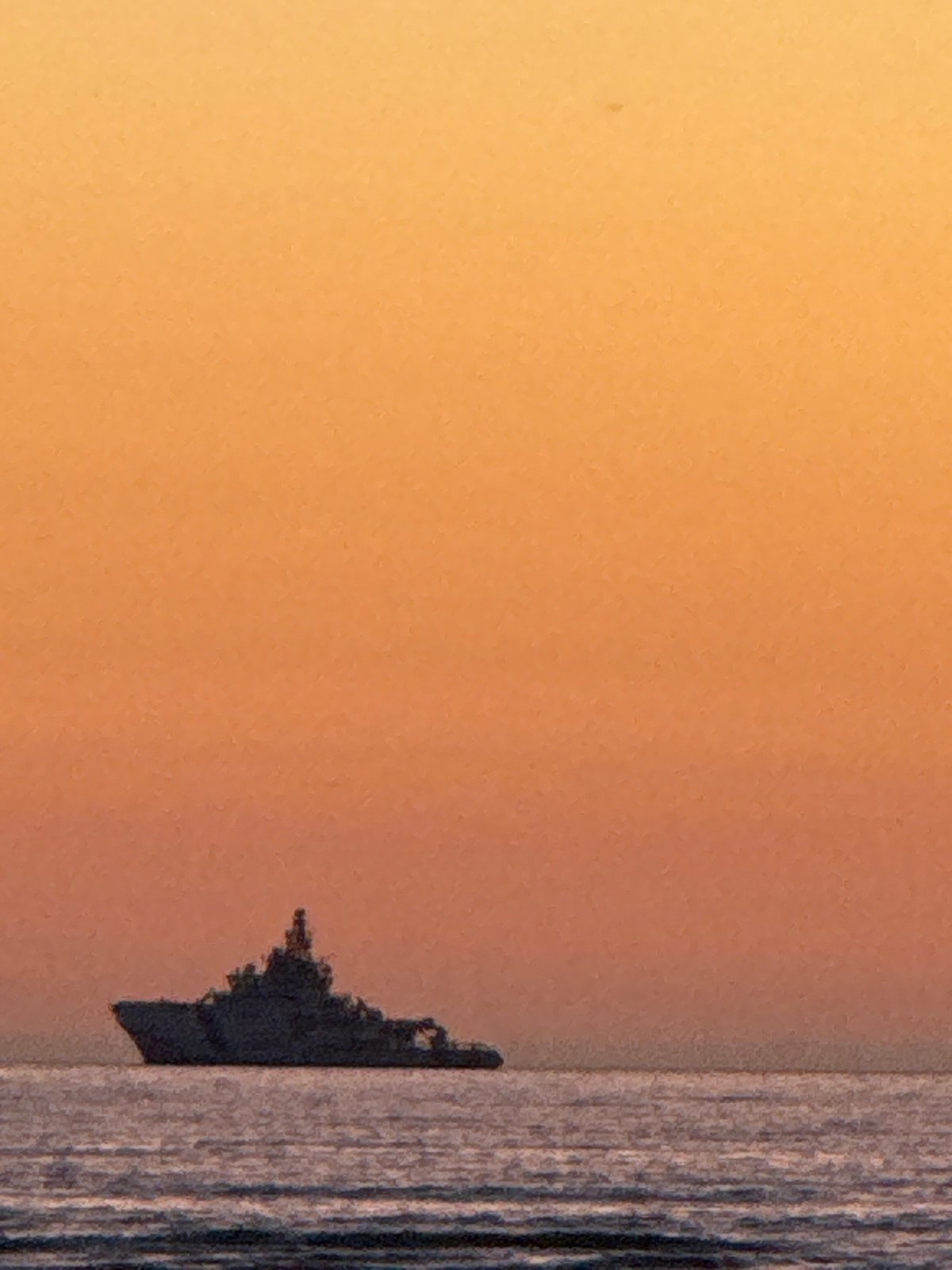 Sunset watchers gather along Tallinn's Baltic coast for evening display