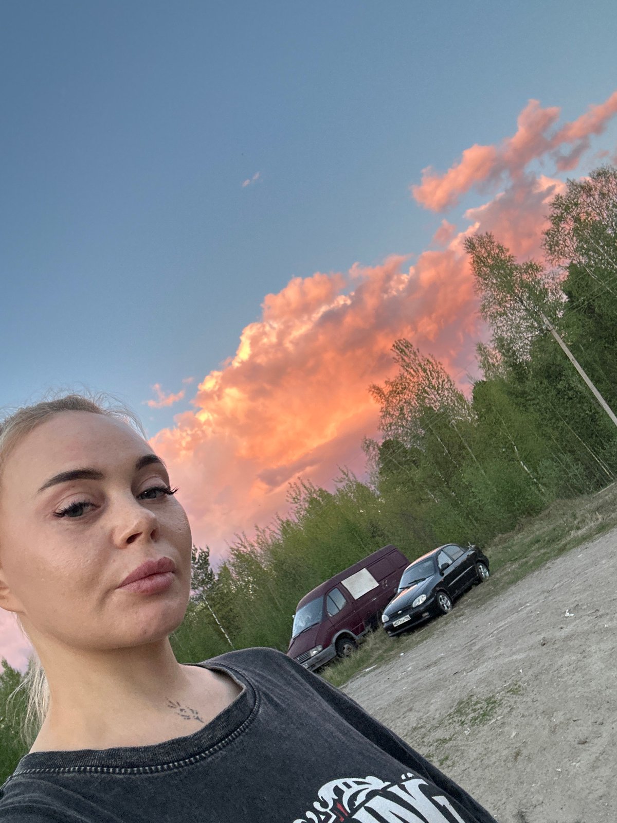Woman photographs sunset with dog in Russian town