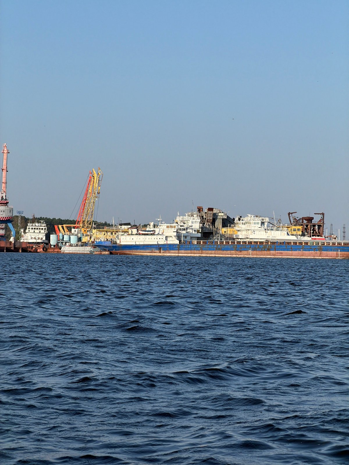 Paddleboarding past working boats on the Kama River