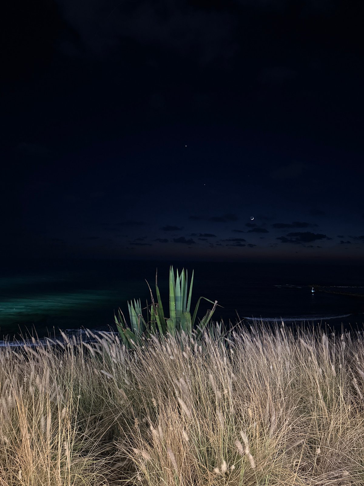 Bat Yam beachfront at night, crescent moon over calm sea