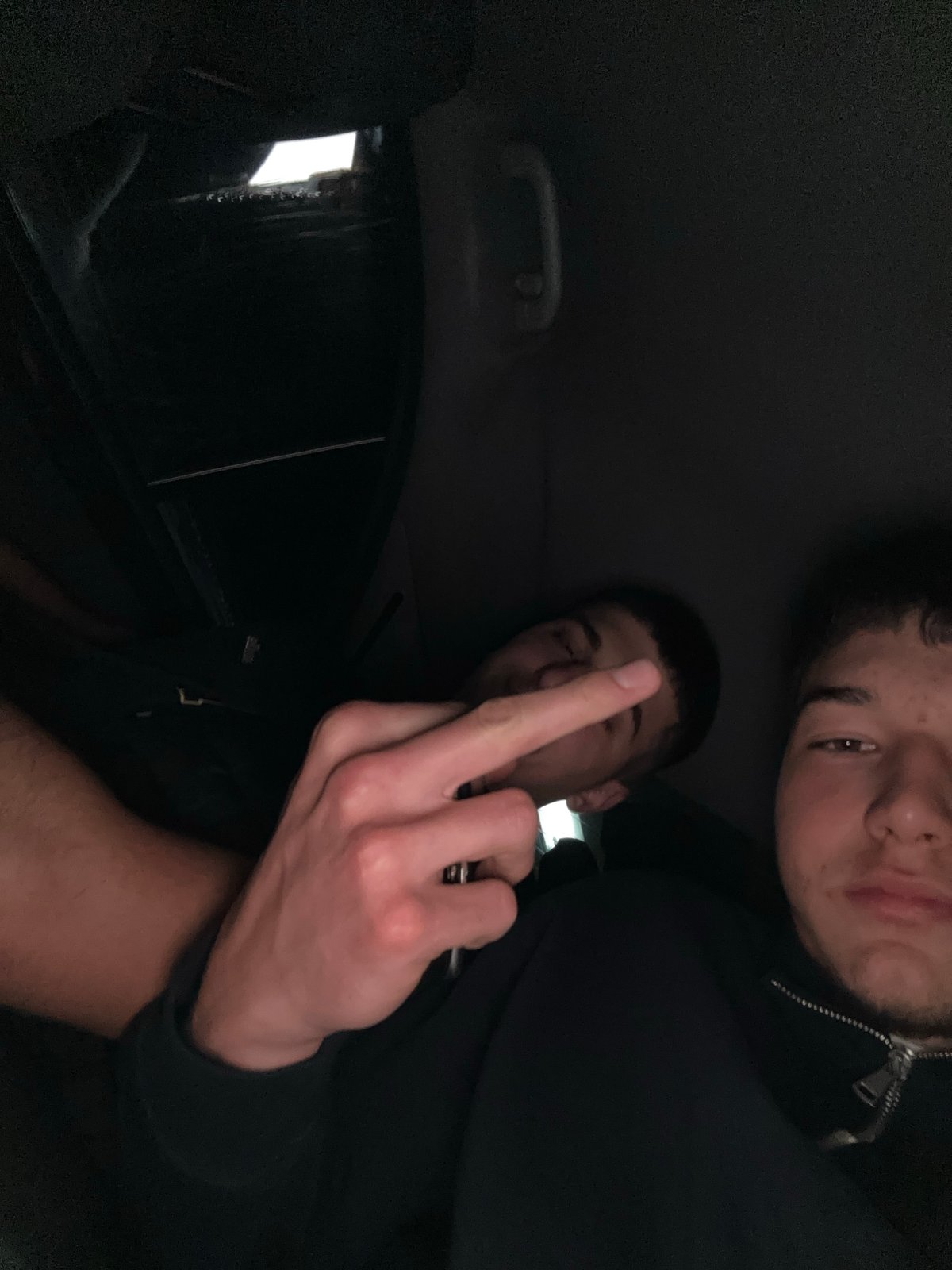 Two men in vehicle, one making obscene gesture, Zlatograd