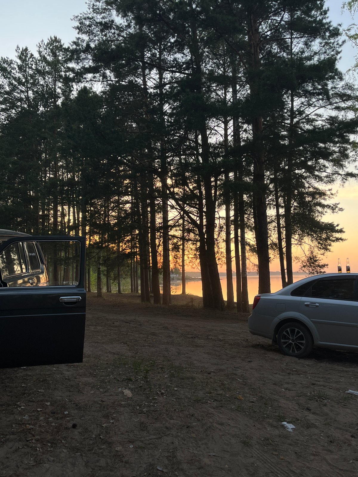 Couple holds hands in car during Chaikovsky sunset