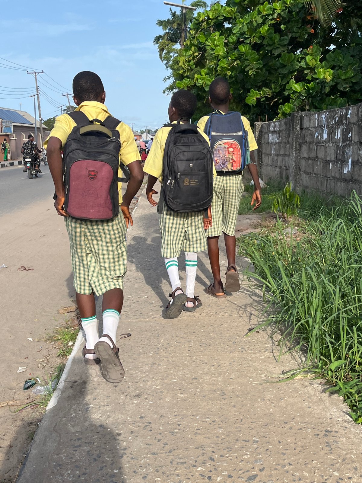 School children in uniforms walk streets of Badagry Nigeria