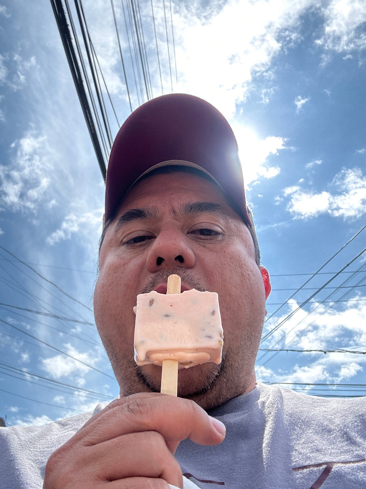 Man enjoys popsicle outdoors in Chipilo, Mexico