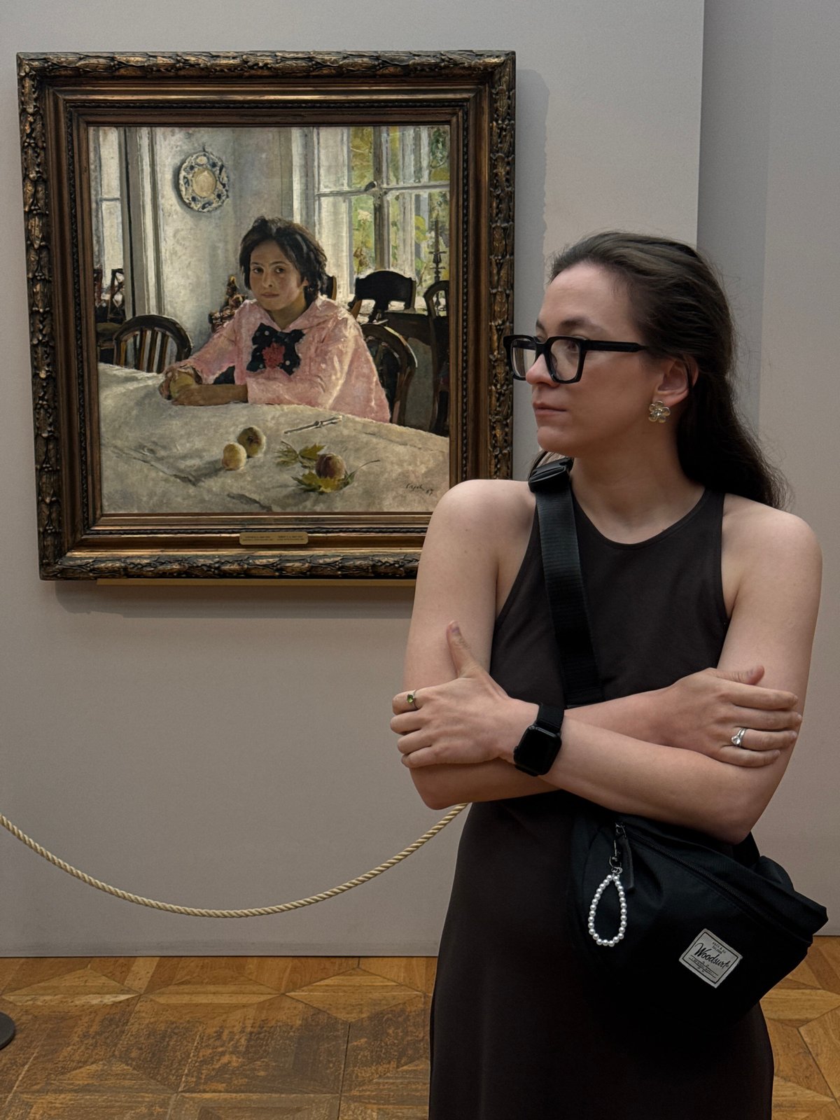 Woman views framed artwork in Moscow gallery or museum