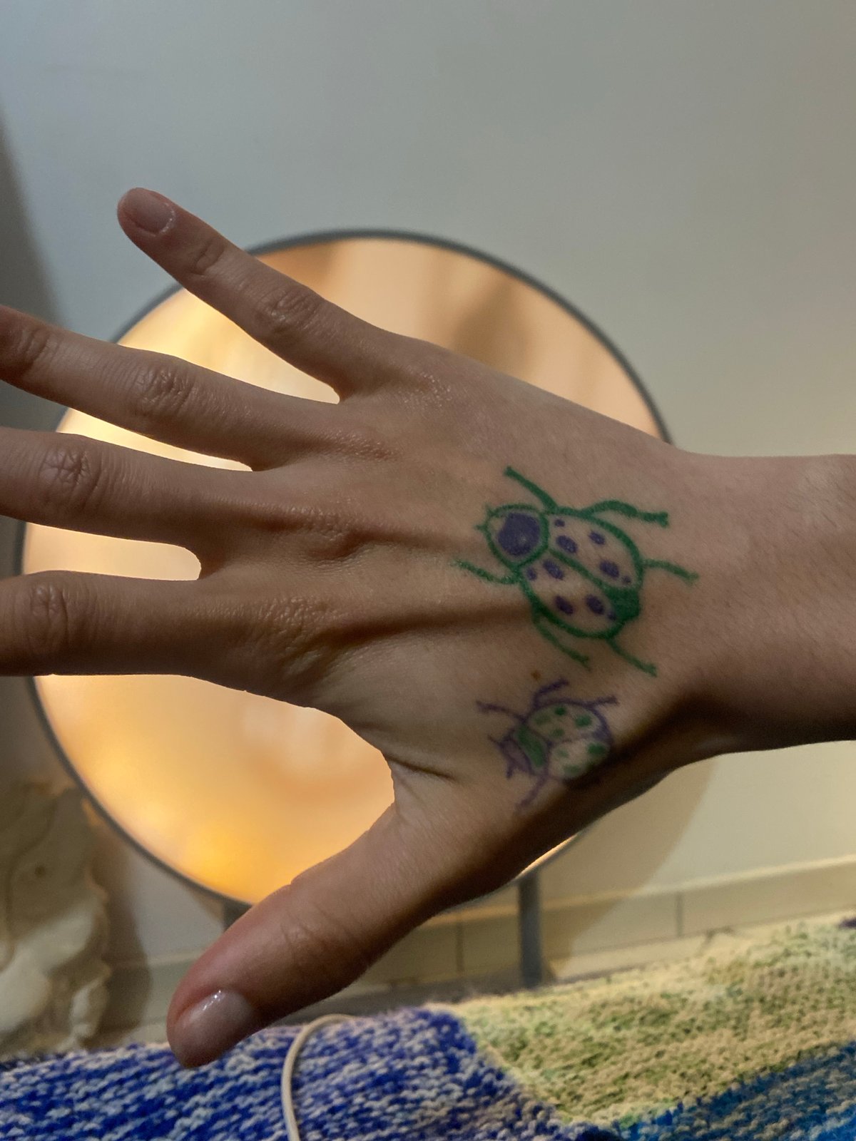 Hand art features colorful ladybug drawings in Aubervilliers